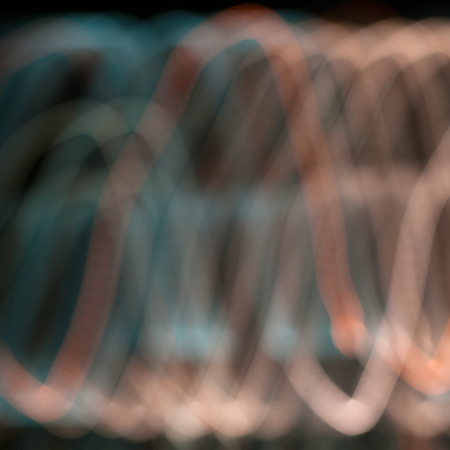 Abstract colored path defocused lights on dark background