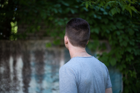 portrait of a man against the background of the wall with greens in cold tonesの写真素材