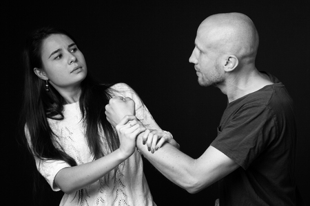 Domestic violence- a man fighting with a woman, black and whiteの写真素材