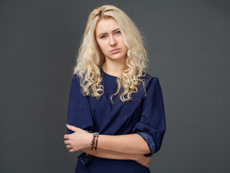 portrait of sad woman on a gray backgroundの写真素材