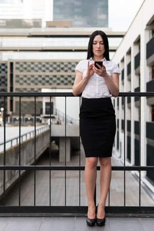 Successful business woman using smart phone in the cityの写真素材