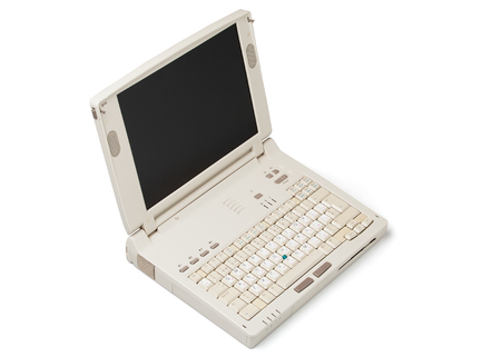 Old laptop computer isolated on white backgroundの写真素材