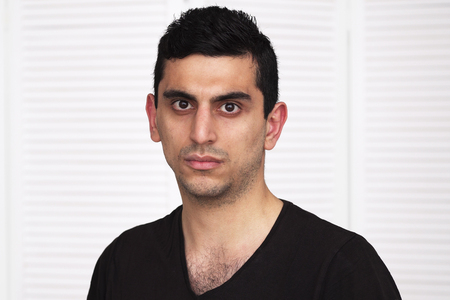 Young serious arabic man looking at cameraの写真素材