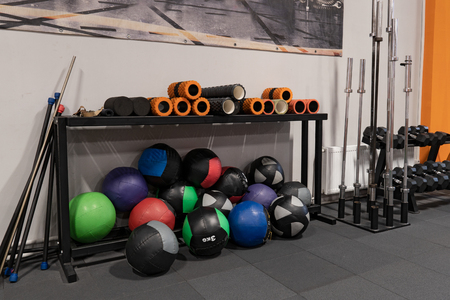 Fitness balls and rods on floor in gym for workoutの写真素材