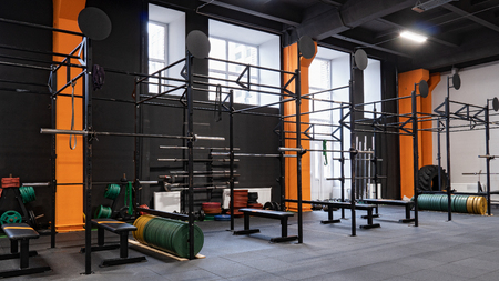 Interior of gym for fitness training with horizontal bar and barbellsの写真素材