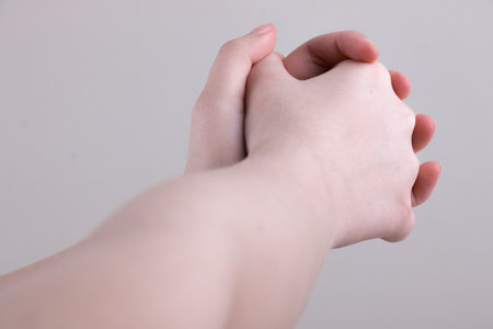 Two kids arms with with closed palmsの写真素材
