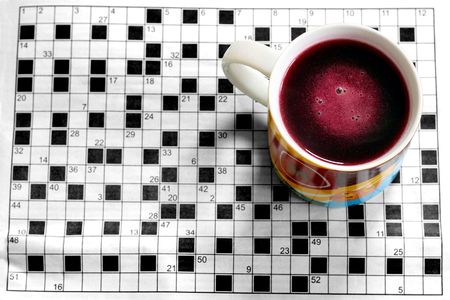 A colourful cup with crossword in backgroundの写真素材