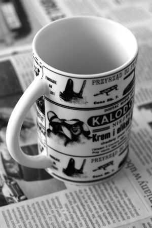 empty cup with newspaper in backgroundの写真素材