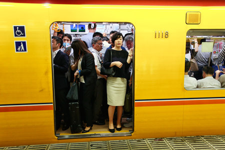 Tokyo, Japan - August 10, 2016: Passengers traveling by Tokyo metro. Business people commuting to work by public transport in rush hour. In Tokyo, Japanのeditorial素材