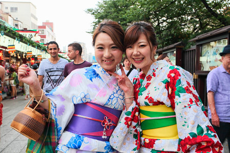 Tokyo, Japan - August 10, 2016: Modern japanese girls in traditional kimono on the way to the temple, Asakusa districtのeditorial素材