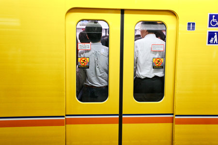 Tokyo, Japan - August 10, 2016: Passengers traveling by Tokyo metro. Business people commuting to work by public transport in rush hour.のeditorial素材