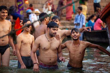 VARANASI, UTTAR PRADESH, INDIA - JULY 7 2018: Pilgrims bathing and performing the holy water. Ganges river in the early morningのeditorial素材