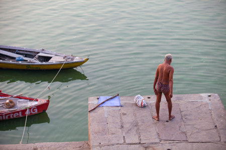 VARANASI, UTTAR PRADESH, INDIA - JULY 7 2018: Pilgrims bathing and performing the holy water. Ganges river in the early morningのeditorial素材