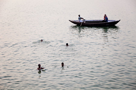 VARANASI, UTTAR PRADESH, INDIA - JULY 7 2018: Pilgrims bathing and performing the holy water. Ganges...