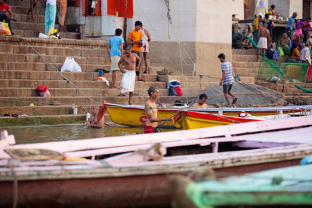 VARANASI, UTTAR PRADESH, INDIA - JULY 7 2018: Pilgrims bathing and performing the holy water. Ganges river in the early morningのeditorial素材