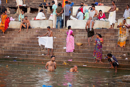 VARANASI, UTTAR PRADESH, INDIA - JULY 7 2018: Pilgrims bathing and performing the holy water. Ganges river in the early morningのeditorial素材