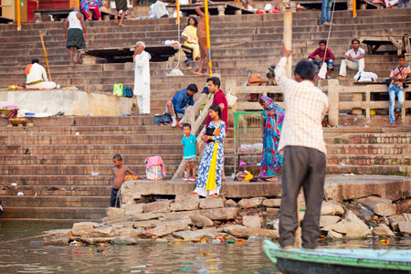 VARANASI, UTTAR PRADESH, INDIA - JULY 7 2018: Pilgrims bathing and performing the holy water. Ganges river in the early morningのeditorial素材