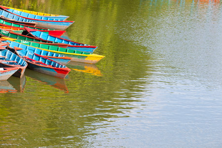 Small wooden boats on the Phewa Lake in Pokhara, Nepal