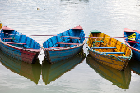 Small wooden boats on the Phewa Lake in Pokhara, Nepalのeditorial素材