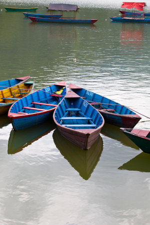Small wooden boats on the Phewa Lake in Pokhara, Nepalのeditorial素材