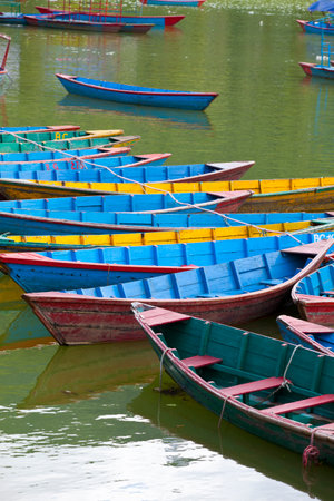Small wooden boats on the Phewa Lake in Pokhara, Nepalのeditorial素材