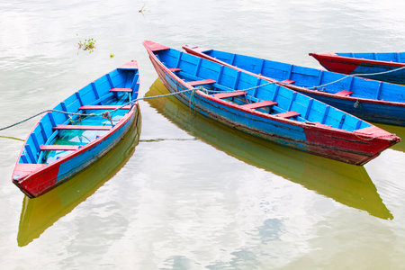 Small wooden boats on the Phewa Lake in Pokhara, Nepalのeditorial素材