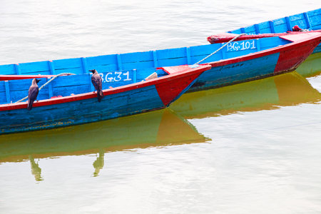 Small wooden boats on the Phewa Lake in Pokhara, Nepalのeditorial素材