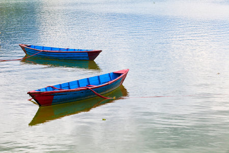 Small wooden boats on the Phewa Lake in Pokhara, Nepalのeditorial素材