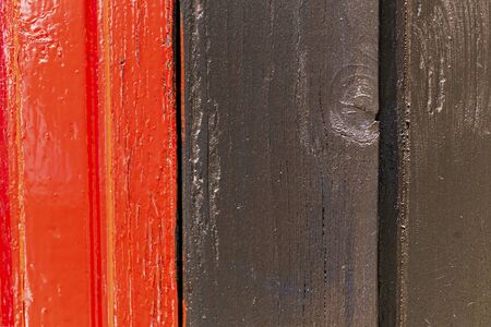 Red and black wooden wall with diferent color pattern.