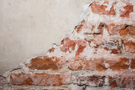 Red brick wall. Red bricks stacked make up the wall. Plaster parts. construction site