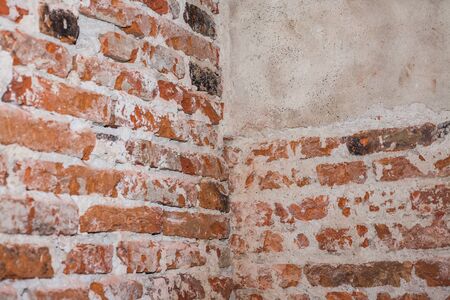 Red brick wall. Red bricks stacked make up the wall. Plaster parts. construction site