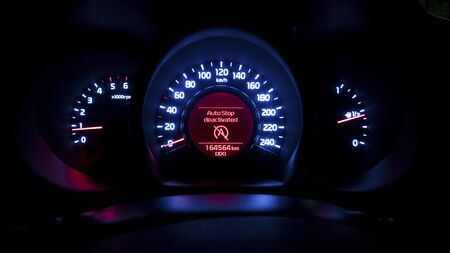 Car instrument panel with auto stop deactivated sing. Luminance of a car instrumental panel. Blue...