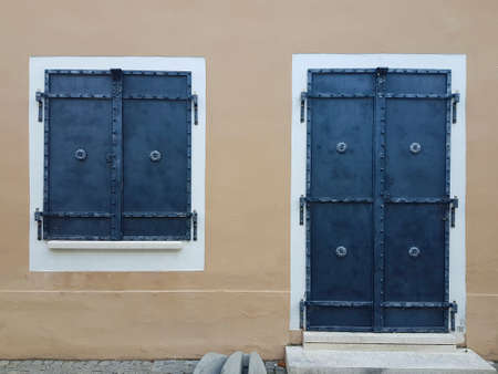 Metal shutters for door and window with forged details.
