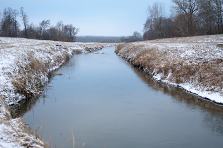 Winter snow river landscape. Morning over snowy winter river. River in winter.の写真素材