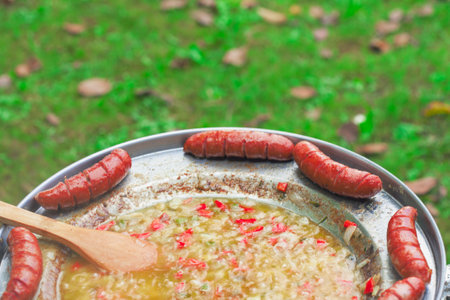 Baked sausages in traditional Croatian dish kotlovina.の写真素材