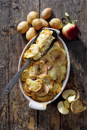 Baked potato with apple and cheese.の写真素材