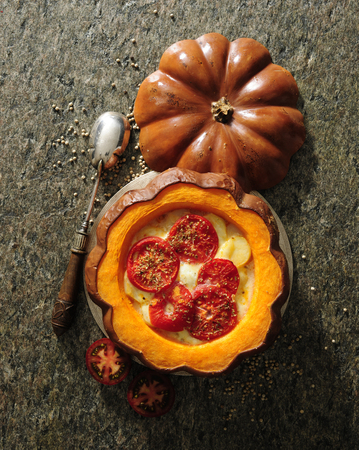 Baked pumpkin stuffed with potato and cheese.の写真素材