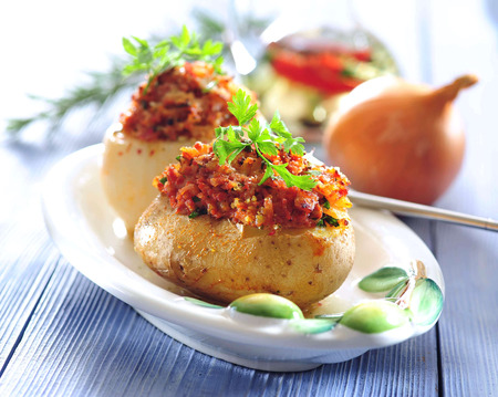 Cheese stuffed baked potatoes and onions.の写真素材