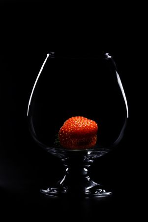 strawberry in a glass on a black backgroundの写真素材