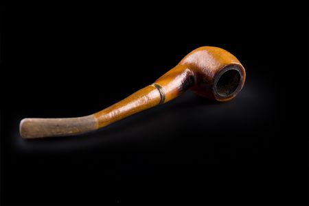 tobacco pipe with smoke isolated on blackの写真素材