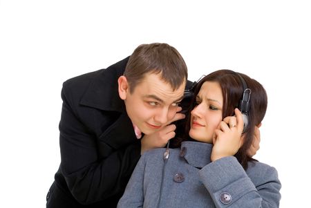 man and woman listen music from one headpnones isolated on white