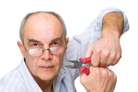serious man in glasses with pliers isolated on whiteの写真素材