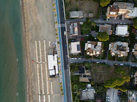 Top view of a coastal town with a beach and beach umbrellas. Terracina, Province of Latina, Lazio...