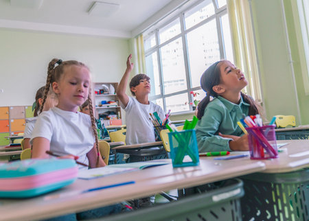 group of elementary school students having fun and learning in classroom at schoolの写真素材