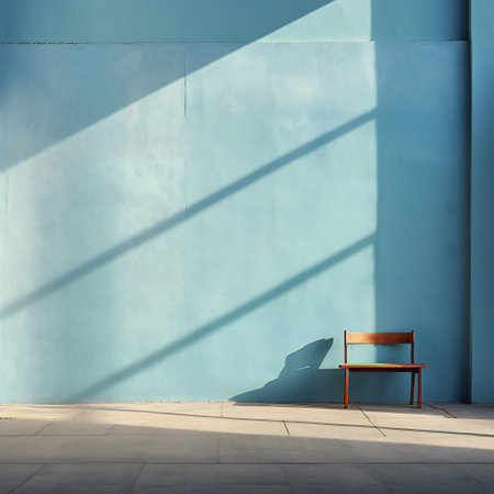 Wooden chair on a blue wall with shadow in a sunny dayの素材