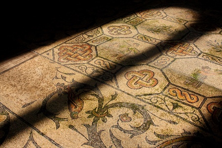 Roman mosaic in old church illuminated by church window