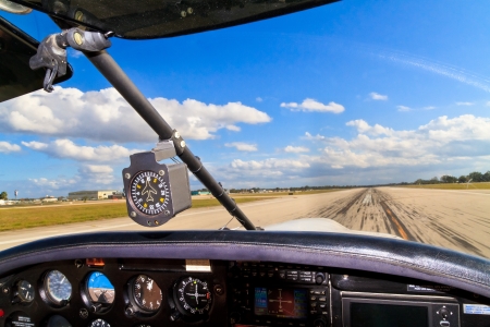 Cockpit view from small aircraft taking off from runwayの写真素材