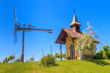 Styrian Tuscany Vineyard with small chapel and windmill, Styria, Austriaの写真素材