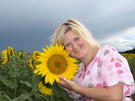 Happy girl in sunflower fieldの写真素材