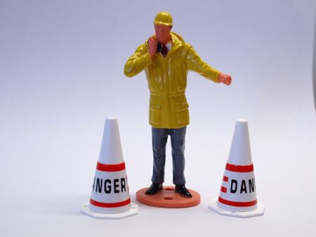 Plastic toy of construction worker with two conesの写真素材